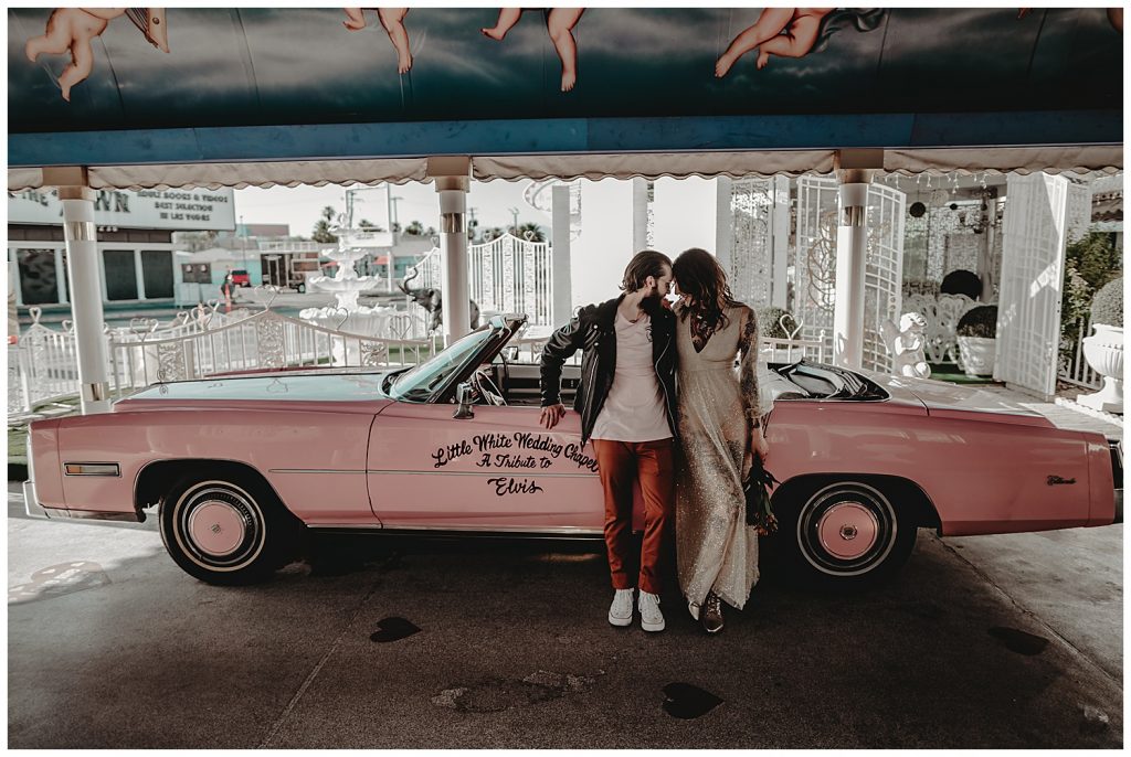 couple in front of pink car