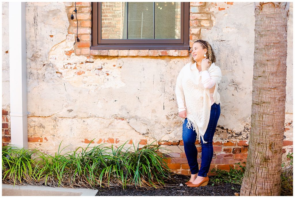 woman in front of brick wall