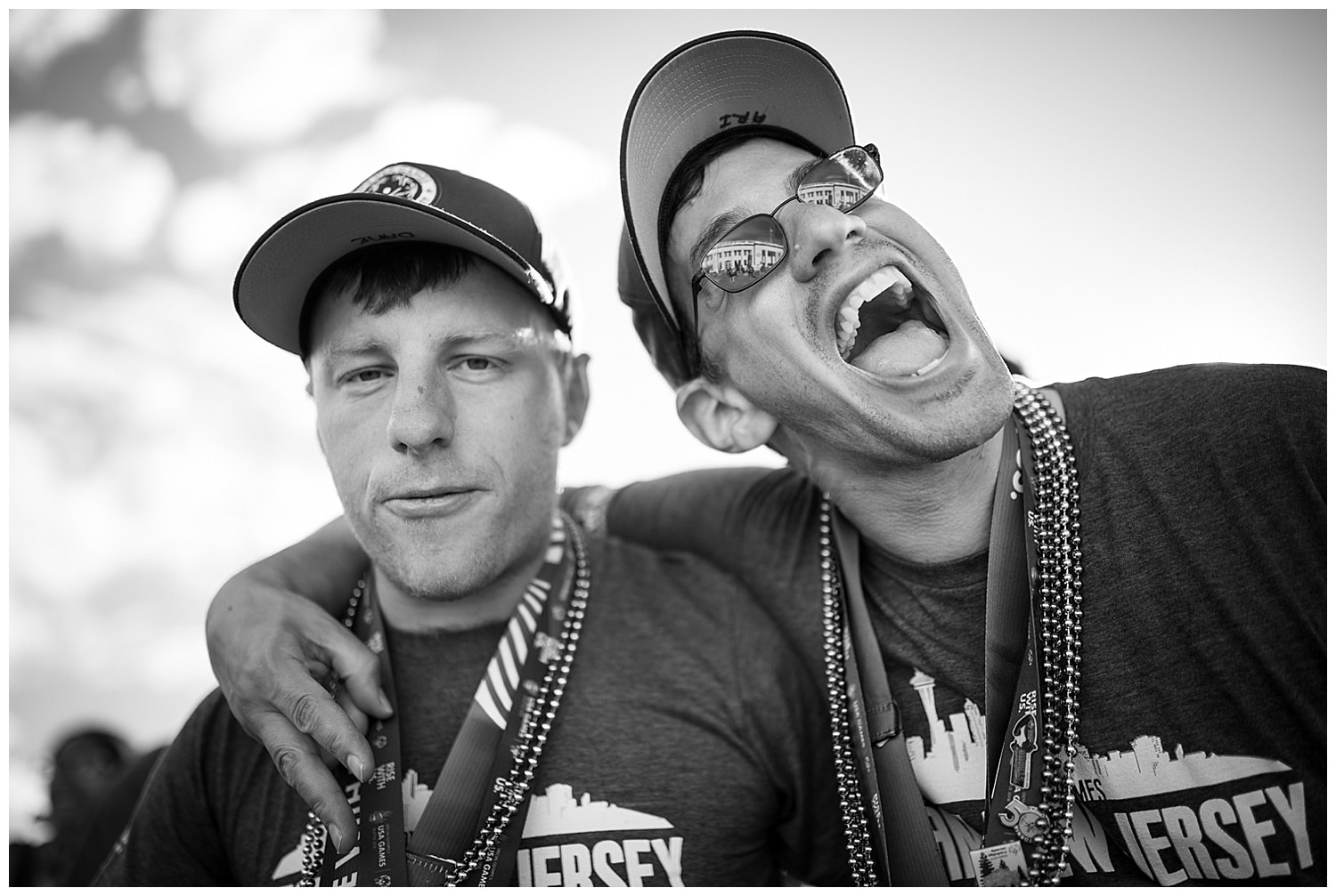 two men embrace and laugh at a special olympics event