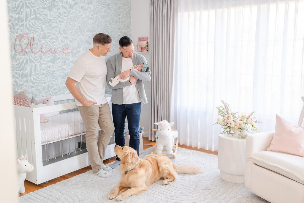 couple with baby and dog in nursery