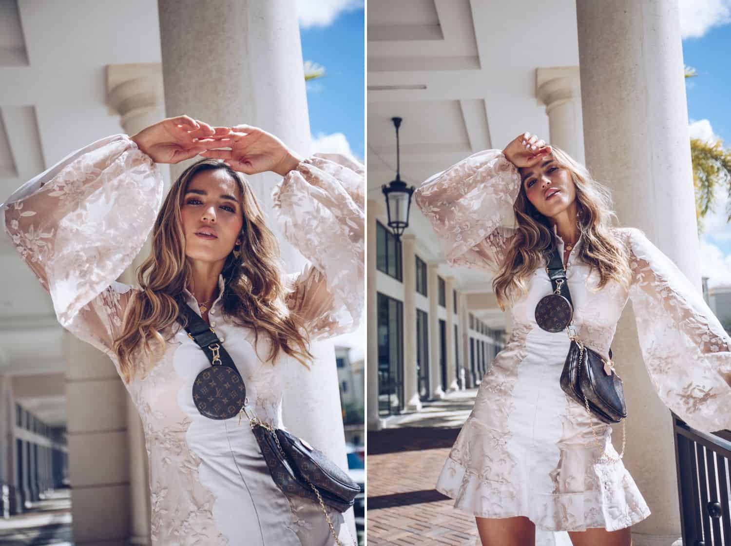 A model with long wavy hair and Louis Vuitton accessories poses outside against a towering white column