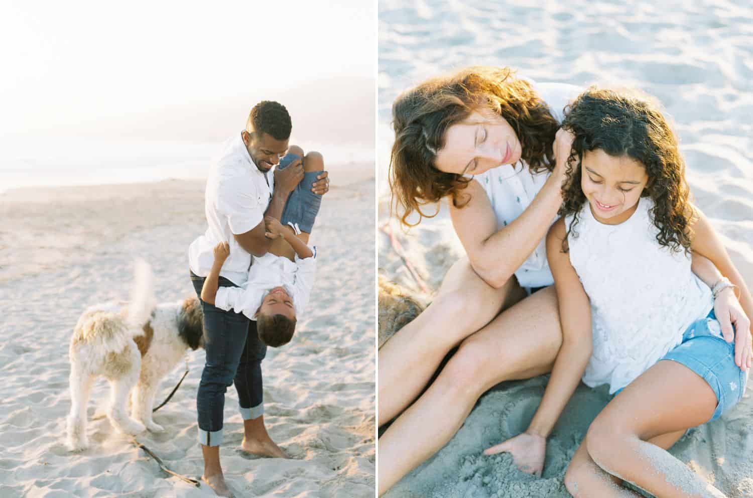 A dad flips his son upside down in a fun moment on the beach. A mom brushes her daughter's hair out of her face as they sit in the sand.