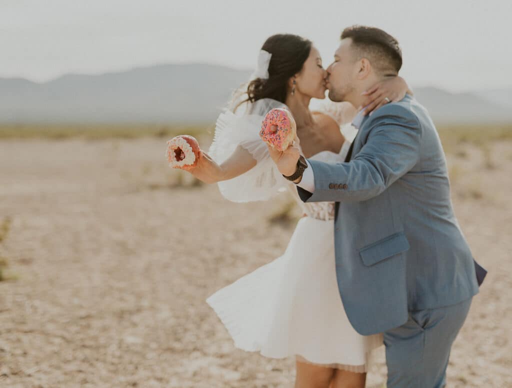 couple holding donuts