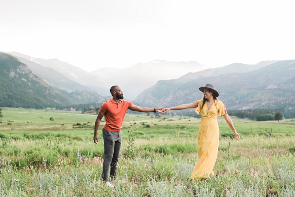 couple arms linked in field