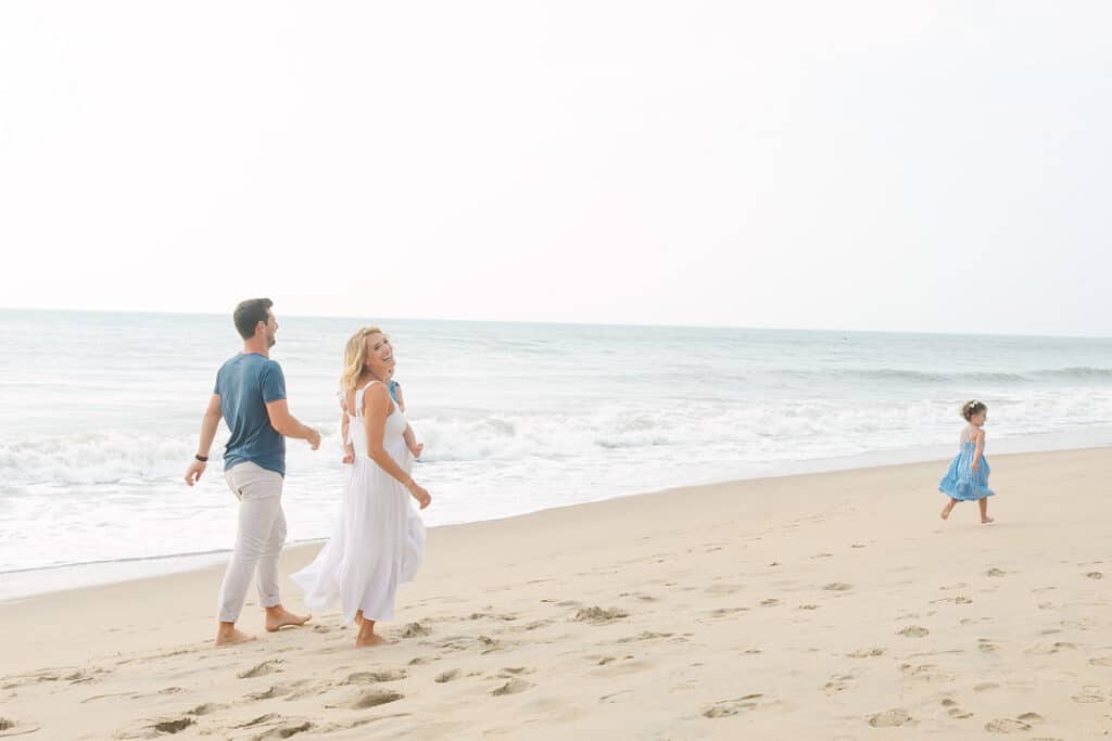 family running on beach