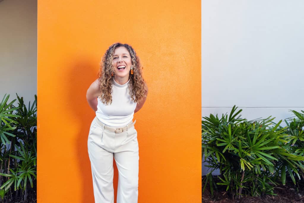 woman in front of orange wall