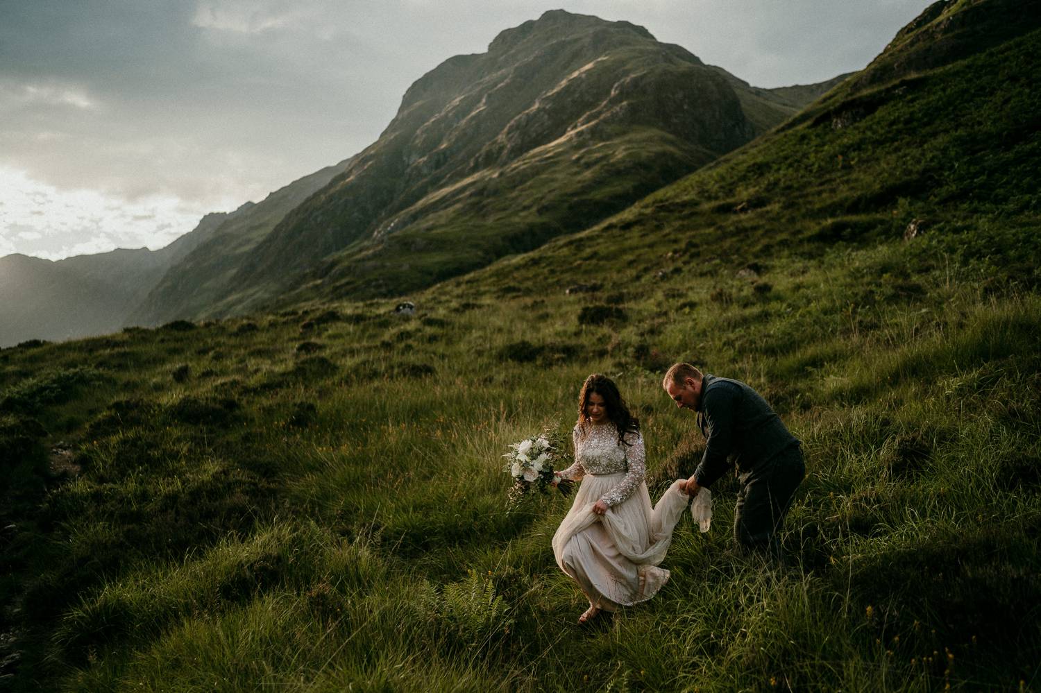 A bride walks delicately down a grassy Irish hill while her groom thoughtfully carries her train. Selling photography prints is simple when you prioritize quality over speed or cost. This image was made by Rob Dight.