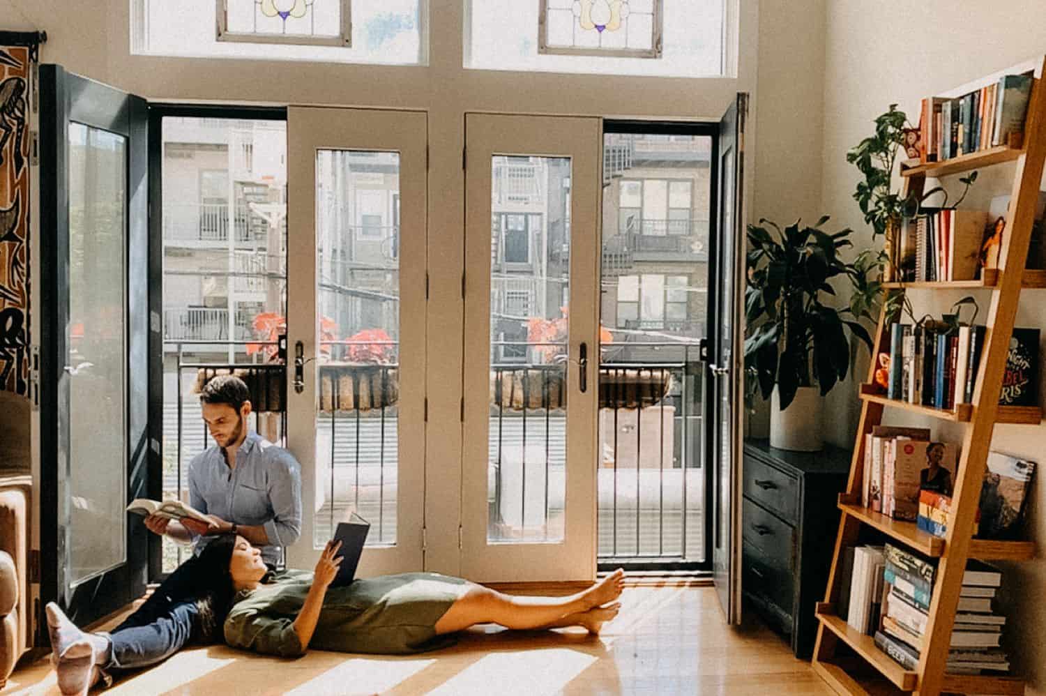 A couple reclines against a wall of windows in this FaceTime photo taken by Barbara O. Photography