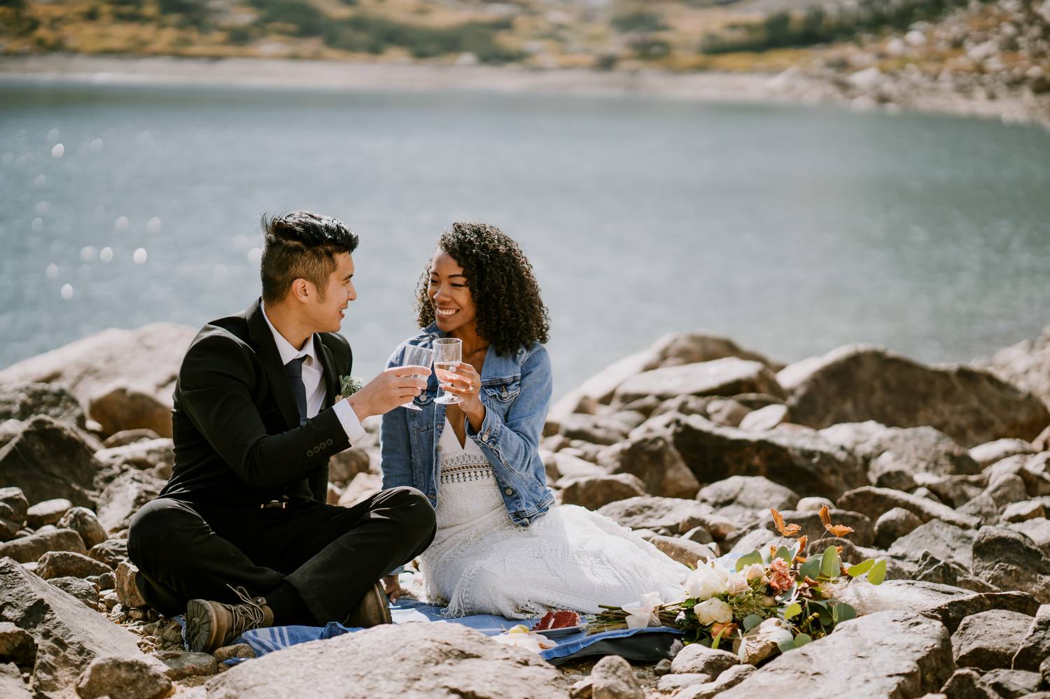 Customer Loyalty: By Nick Sparks, a bride and groom sip wine beside a sparkling lake.