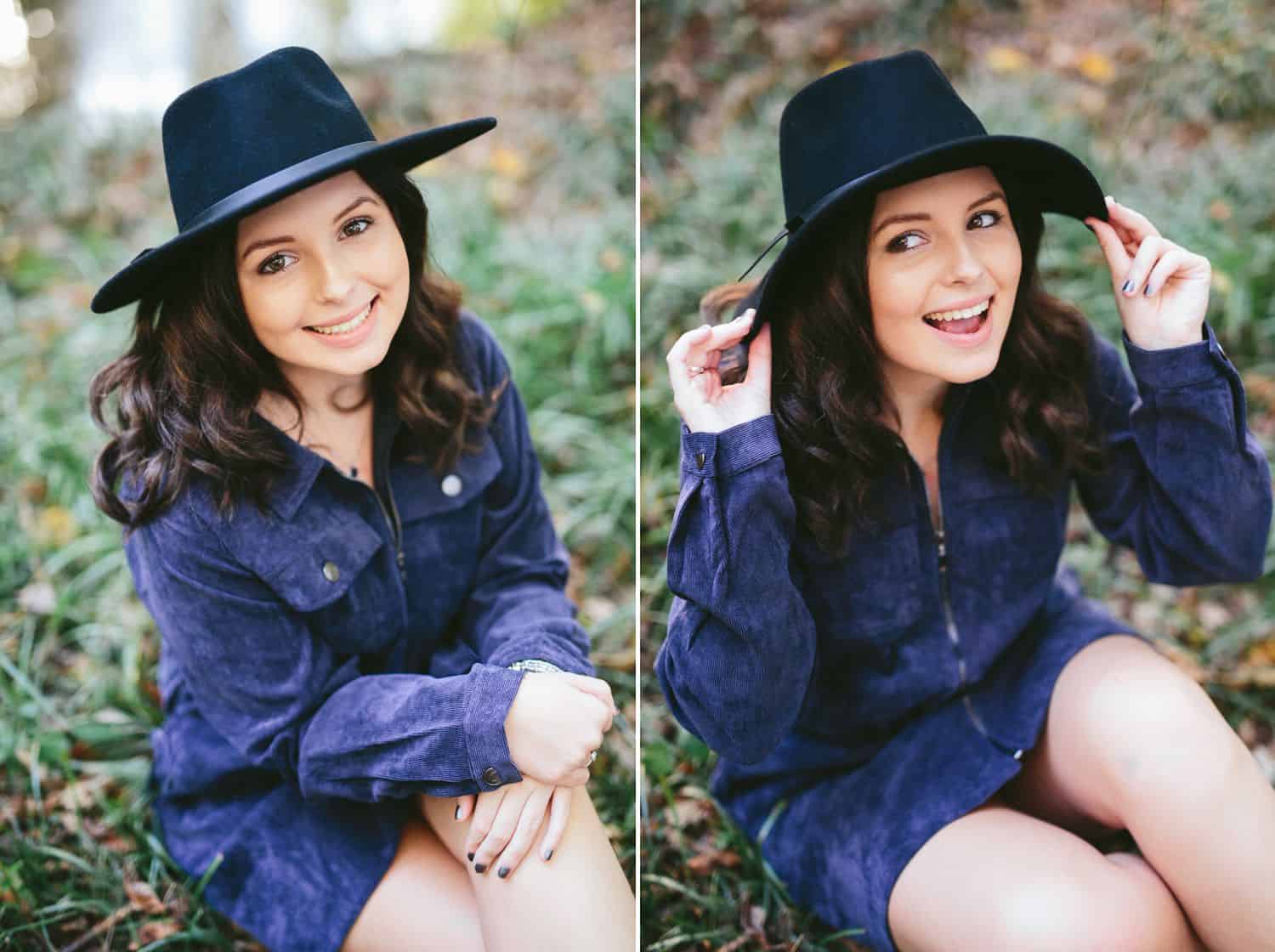 A high school senior girl poses in a denim dress and a black boho hat