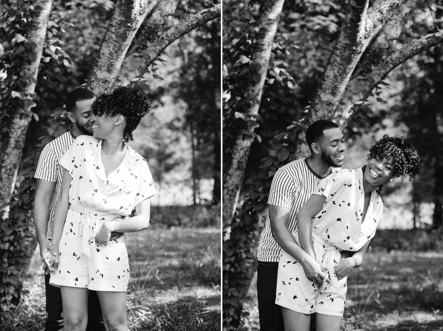 In this series of two black and white photos, a Black couple stands together in a park. The man is slightly behind the woman, with his arms wrapped around her waist. In the first photo, she's turning slightly toward him with a smile on her face. In the second photo, they are both laughing energetically and clinging to one another's hands.