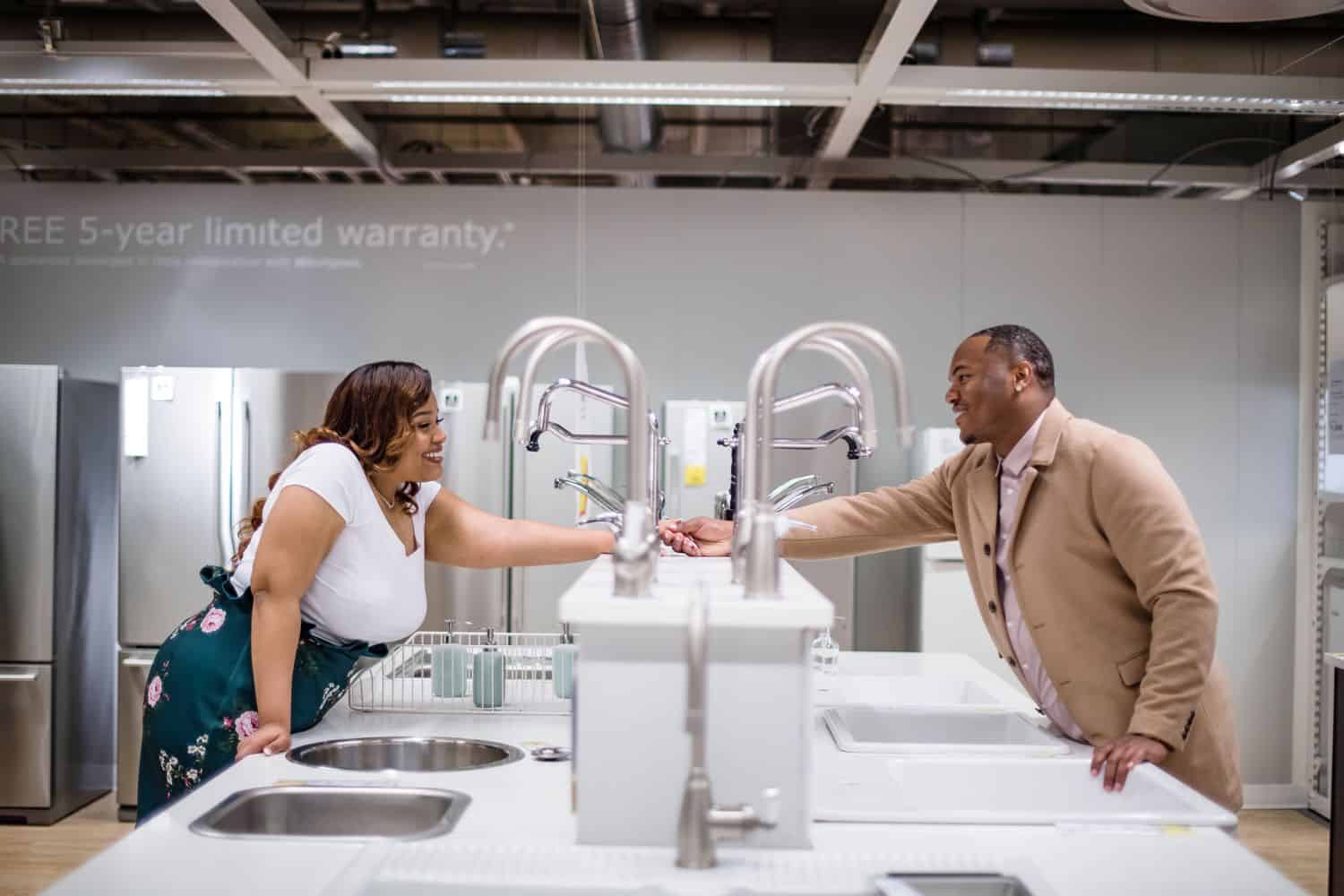 Great Engagement Photos: Couple holds hands in the IKEA sink department.