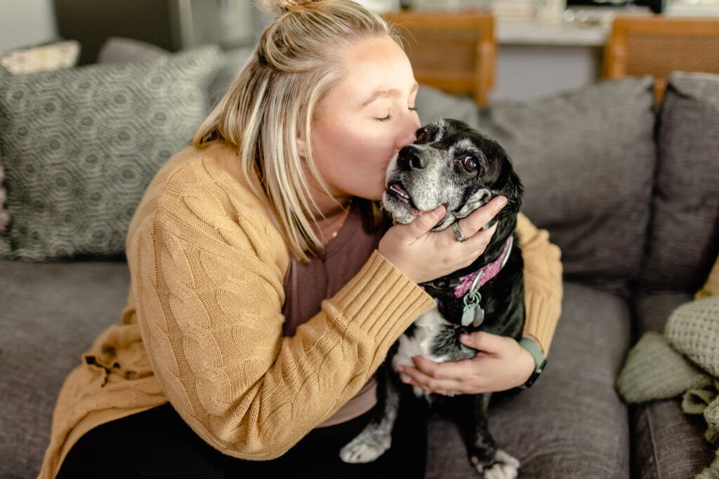 woman kissing dog