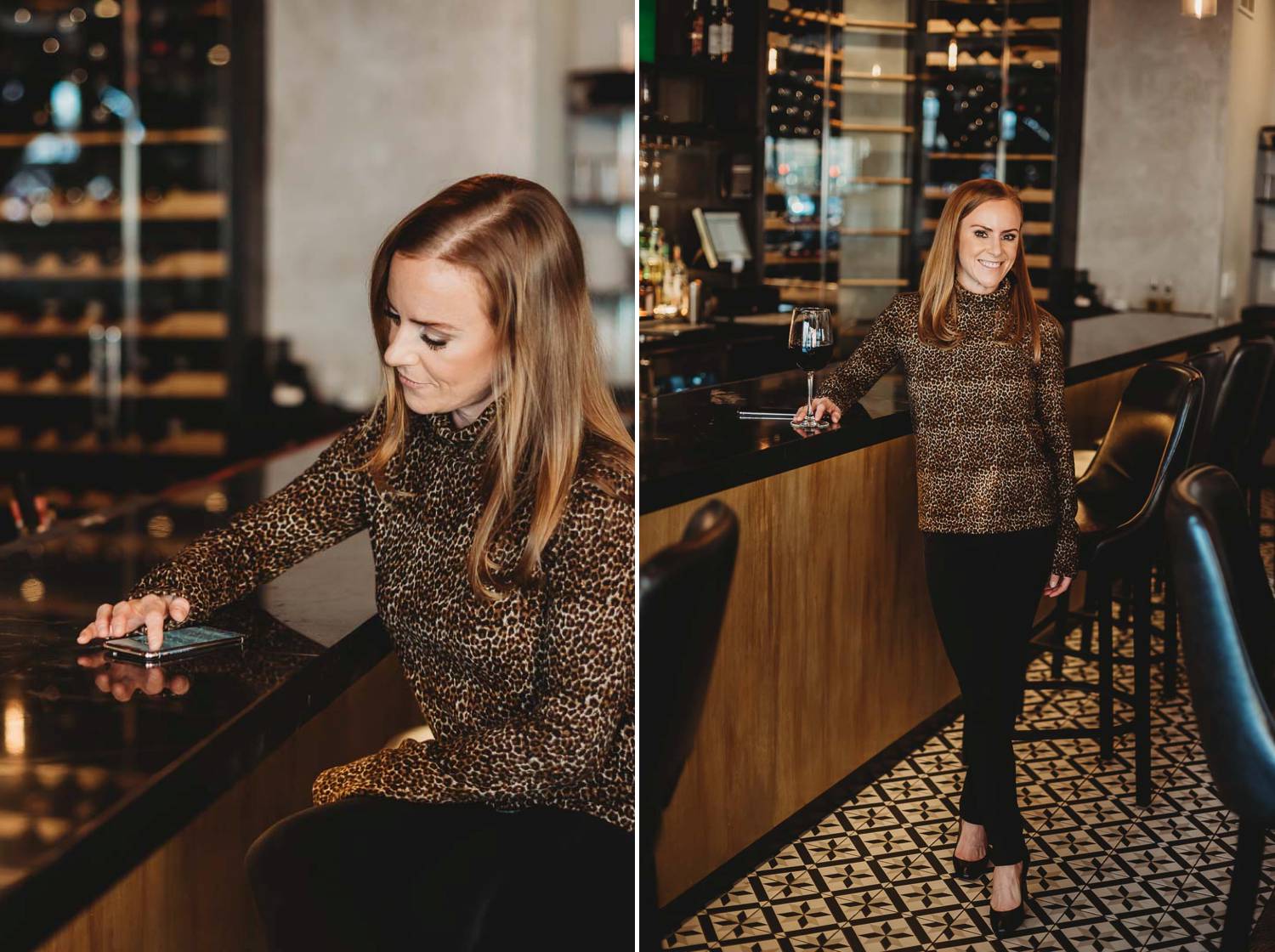 A woman sits at a wine bar in her work attire as she answers emails on her smartphone