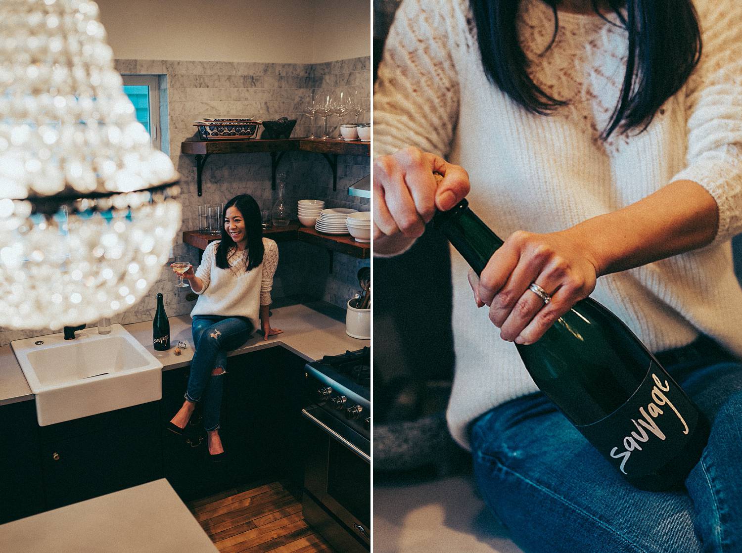 A female entrepreneur opens a bottle of champagne in her kitchen beneath a crystal chandelier. You'll have cause to celebrate, too, if you qualify for COVID relief for photographers. 