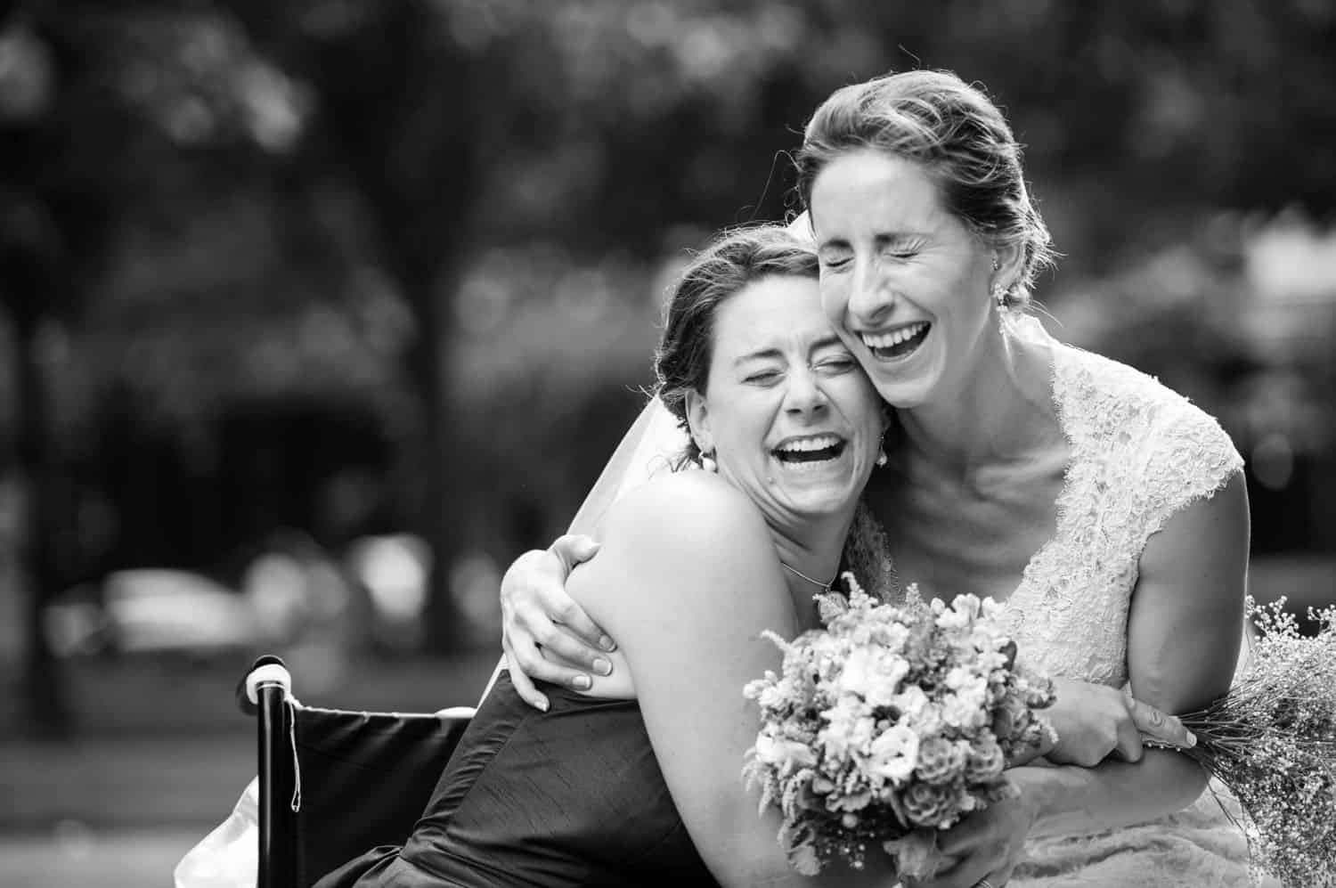 Make Money with Photography: A bride and her bridesmaid hug and laugh