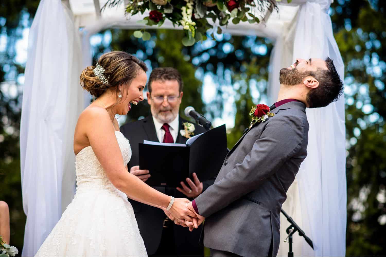 Make Money with Photography: Bride laughs and groom throws back his head while they hold hands mid-ceremony