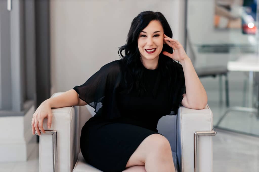 woman in black sitting on chair