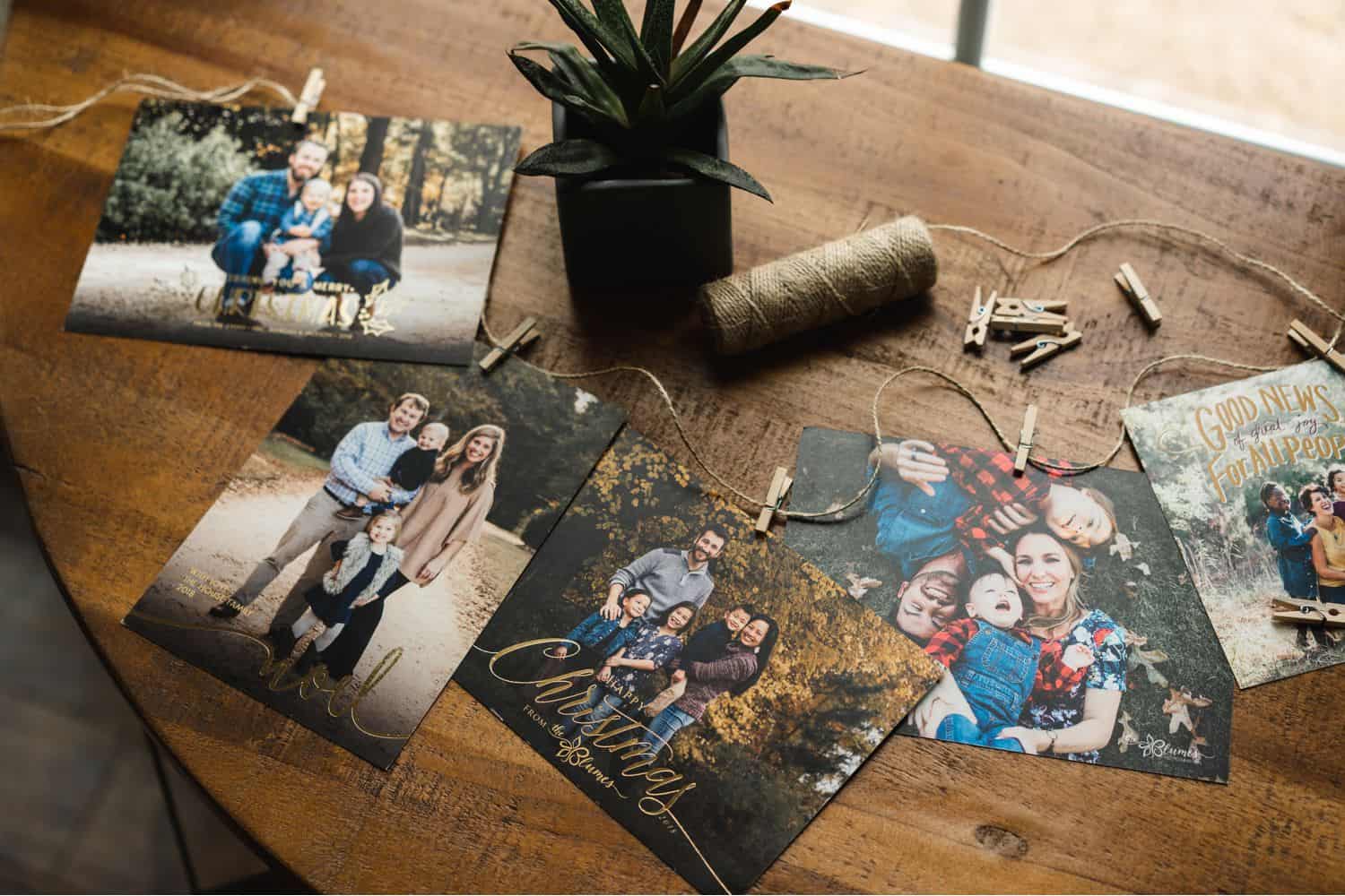 A flatlay of holiday cards are strung on a roll of twine.