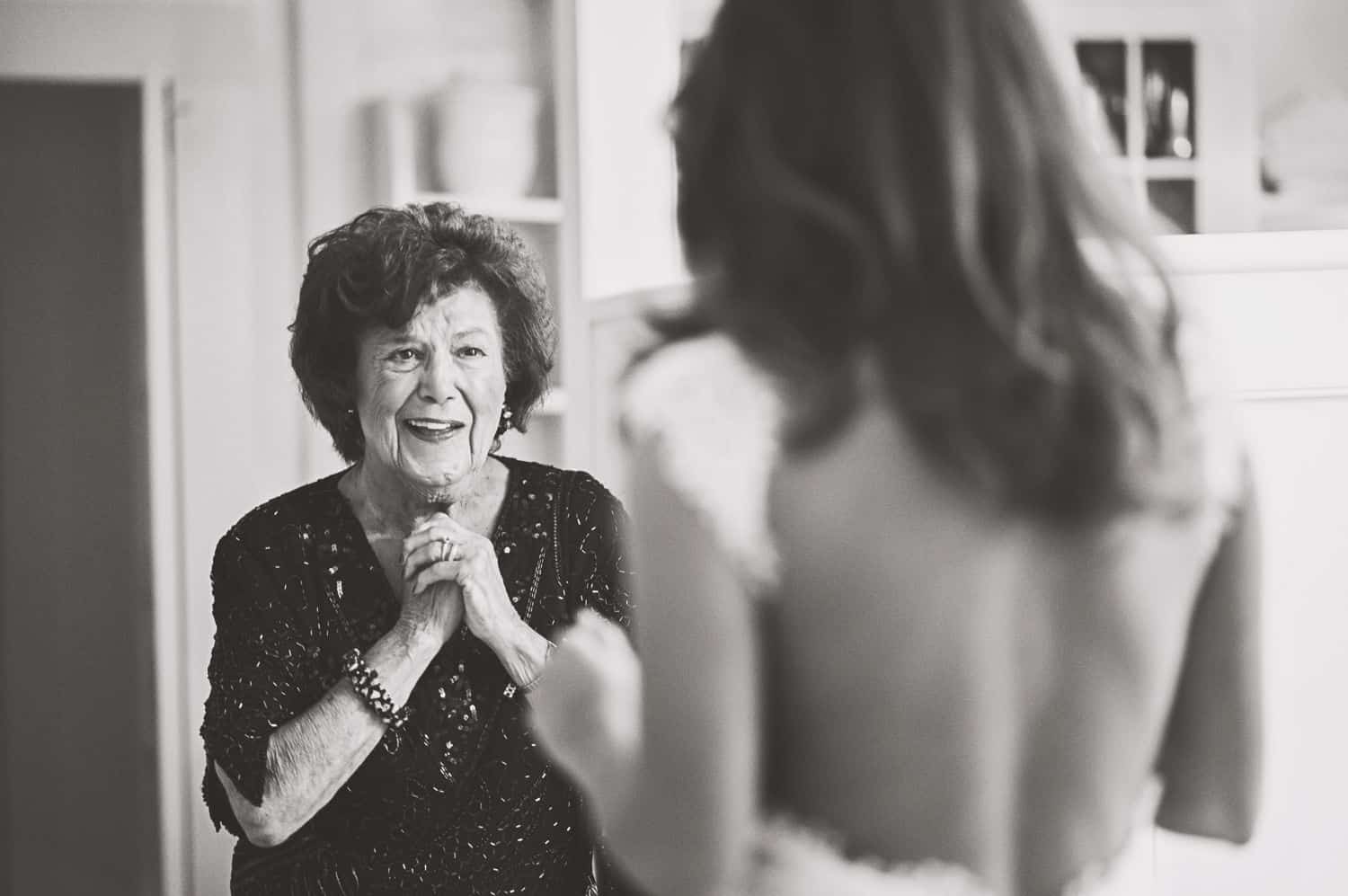 Mother sees daughter in wedding dress for the first time. By Harris & Co.