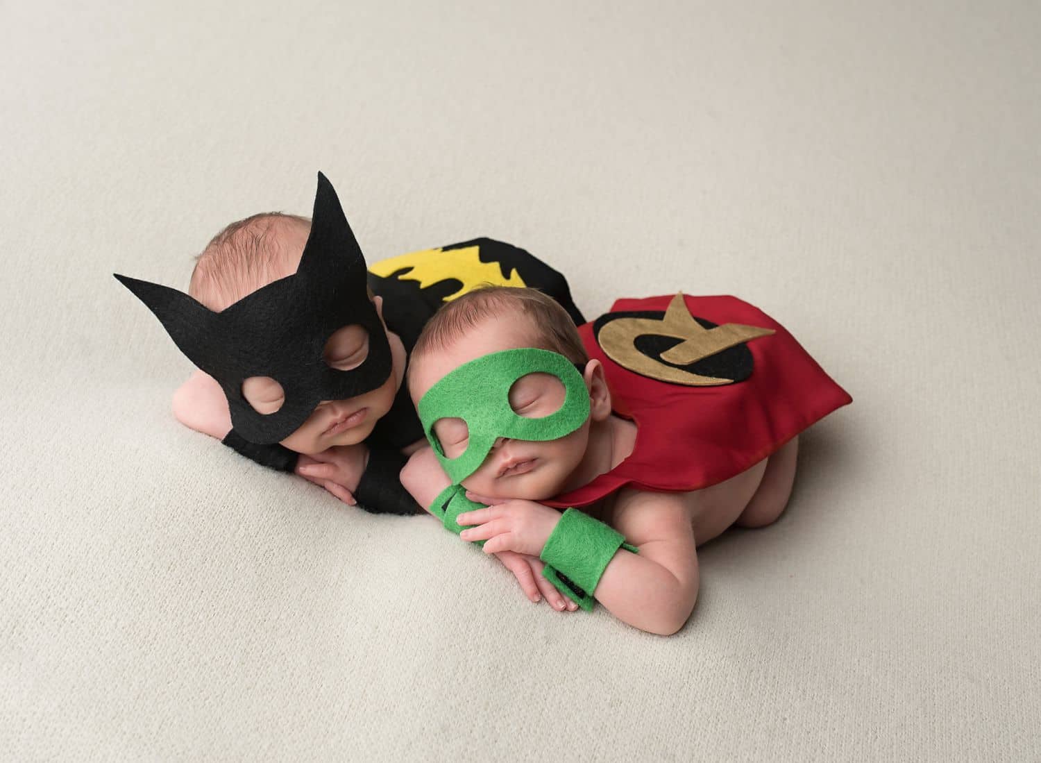 Two of the best newborn photograph props are these felt masks and miniature caps depicting newborn twins as Batman and Robin!