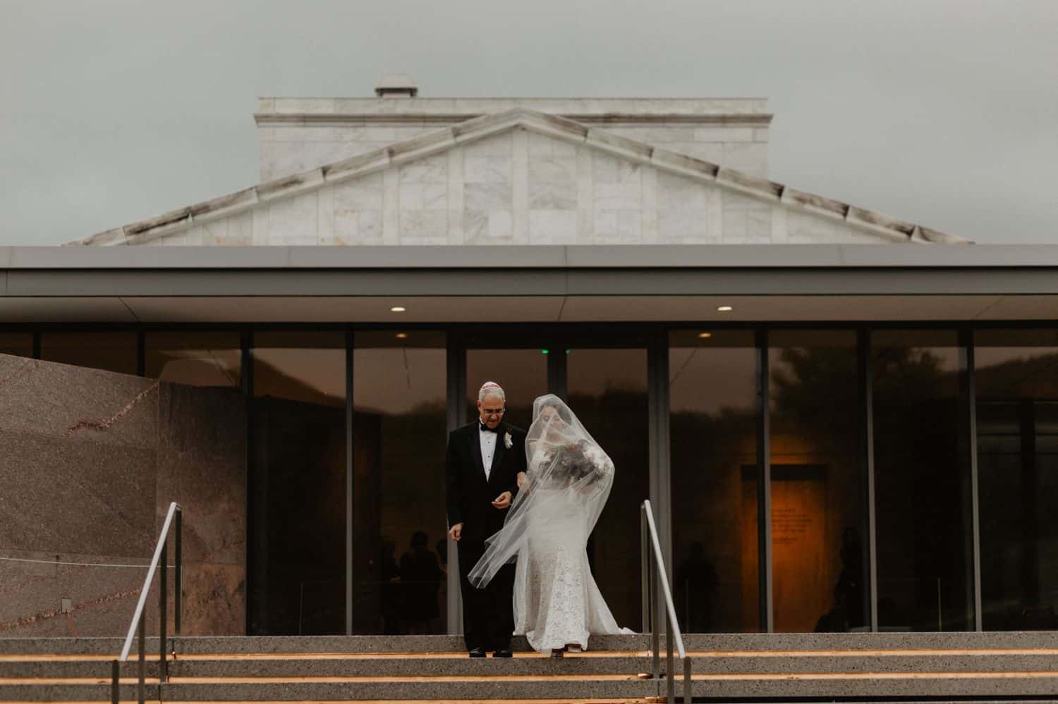 A father walks his daughter down the aisle to get married