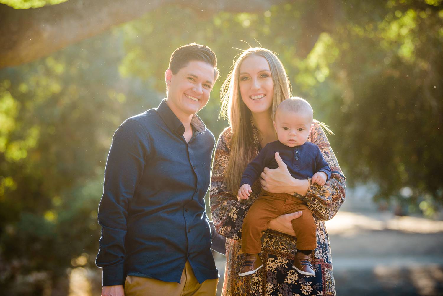 Family portraits outside with sun flare