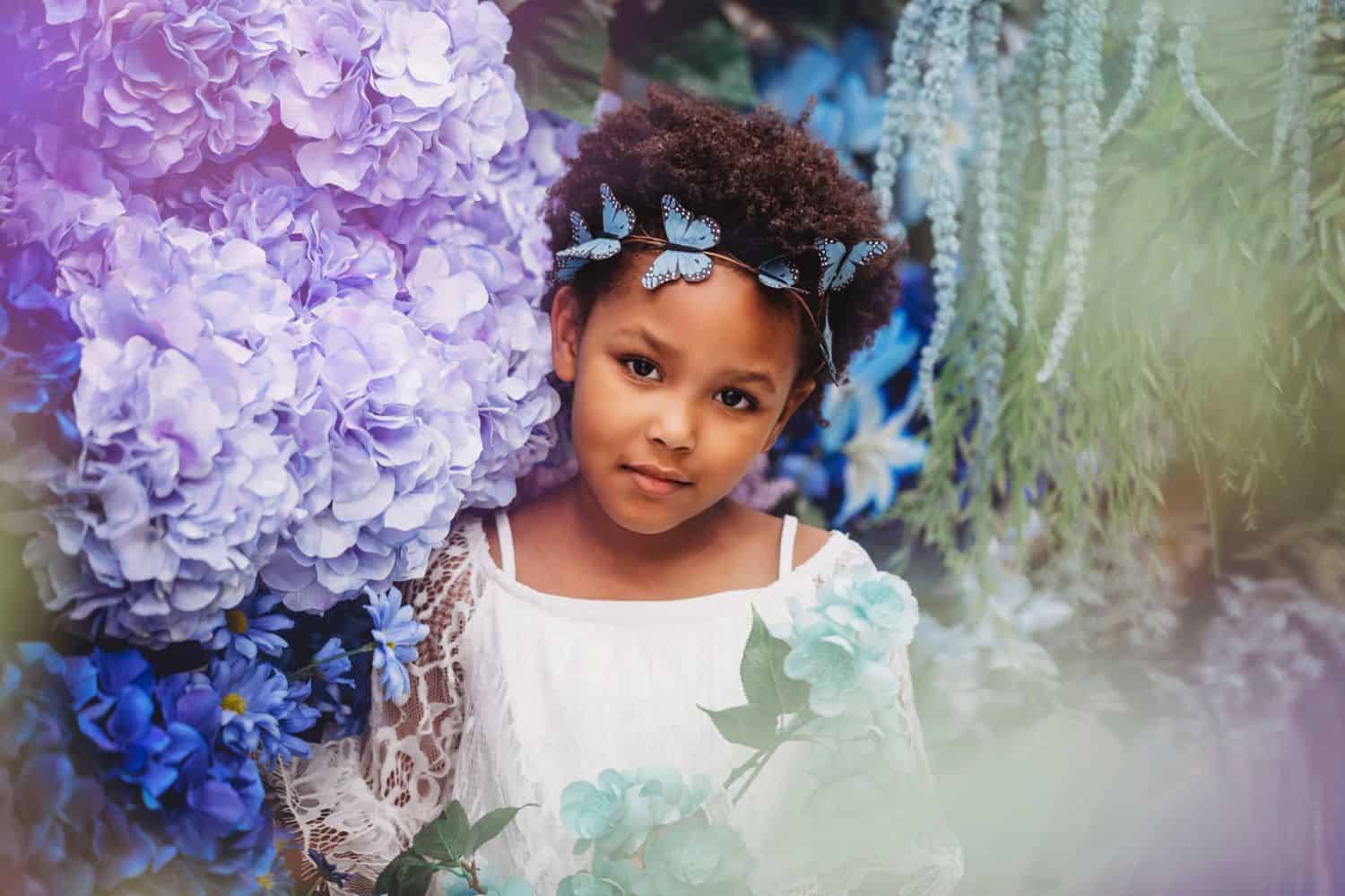 Portrait of little girl among flowers for Michael's Challenge photo project.