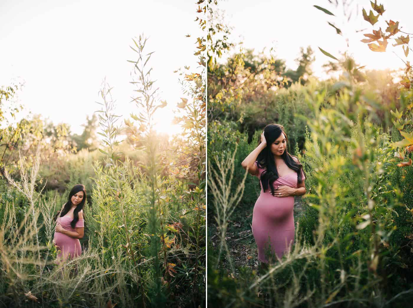 Janae Marie photographs a young pregnant mother in an overgrown field in a pink dress.