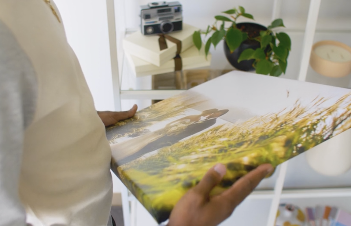 Woman holding a canvas print of a photo