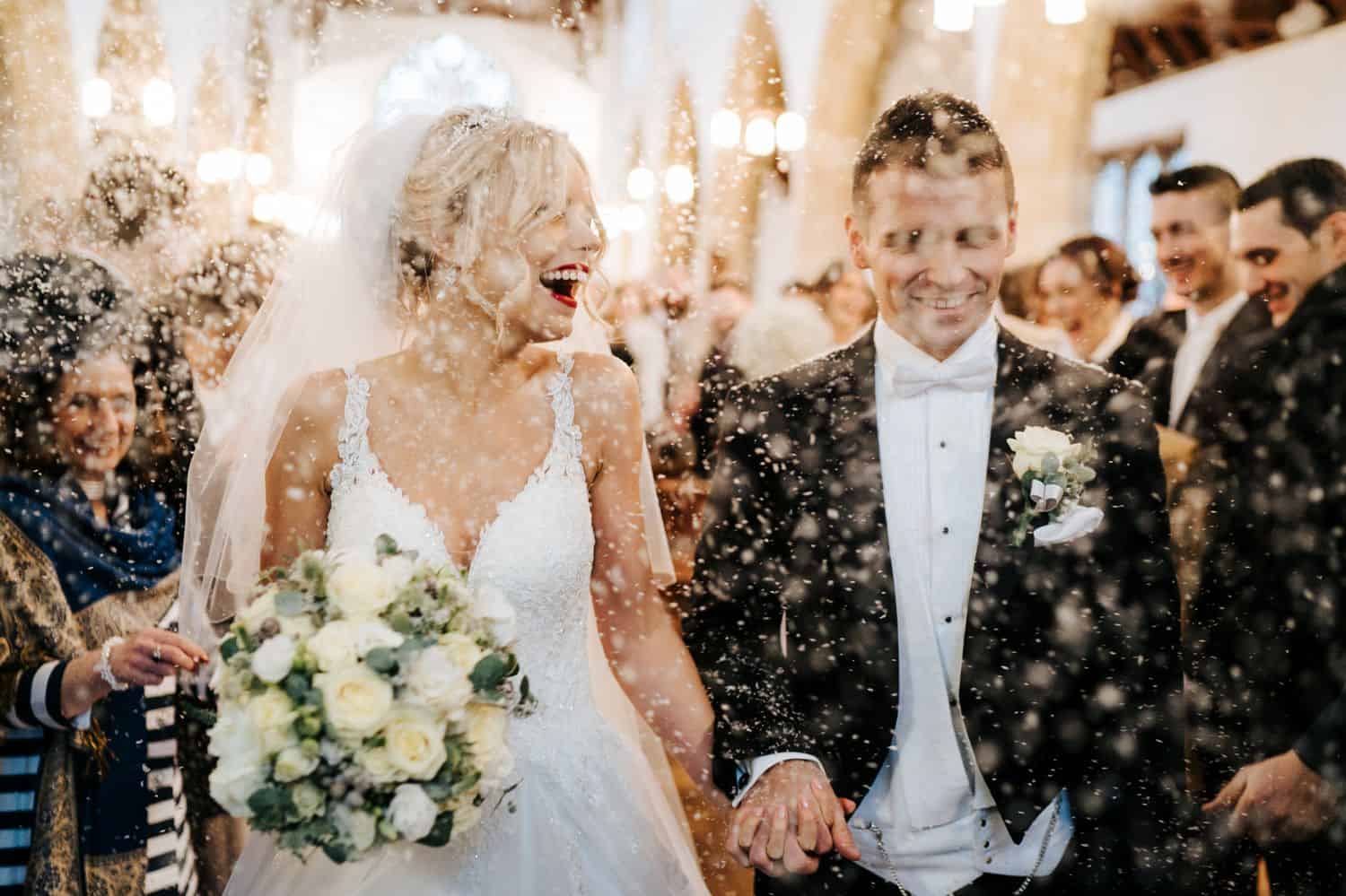 Wedding Print Packages: Bride and groom leave the church in a shower of rice.